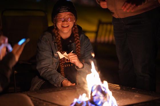 Student by a campfire